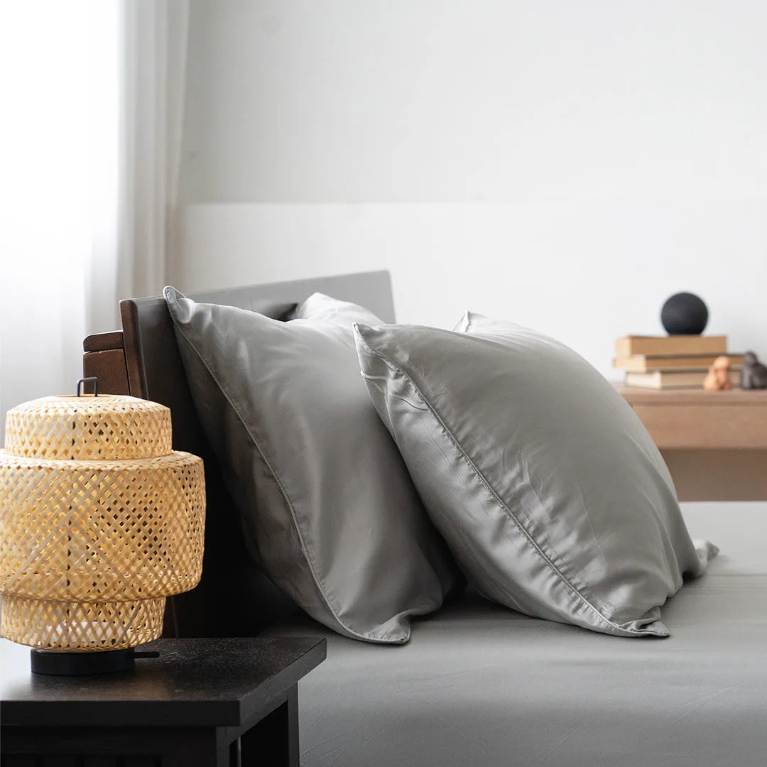 Grey pillows with bamboo lamp