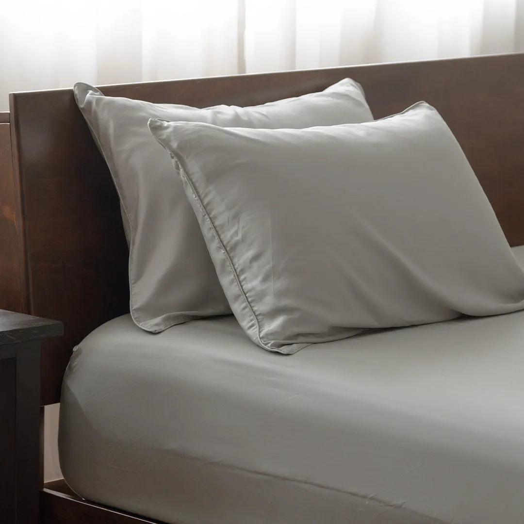 Grey pillows on fitted sheet